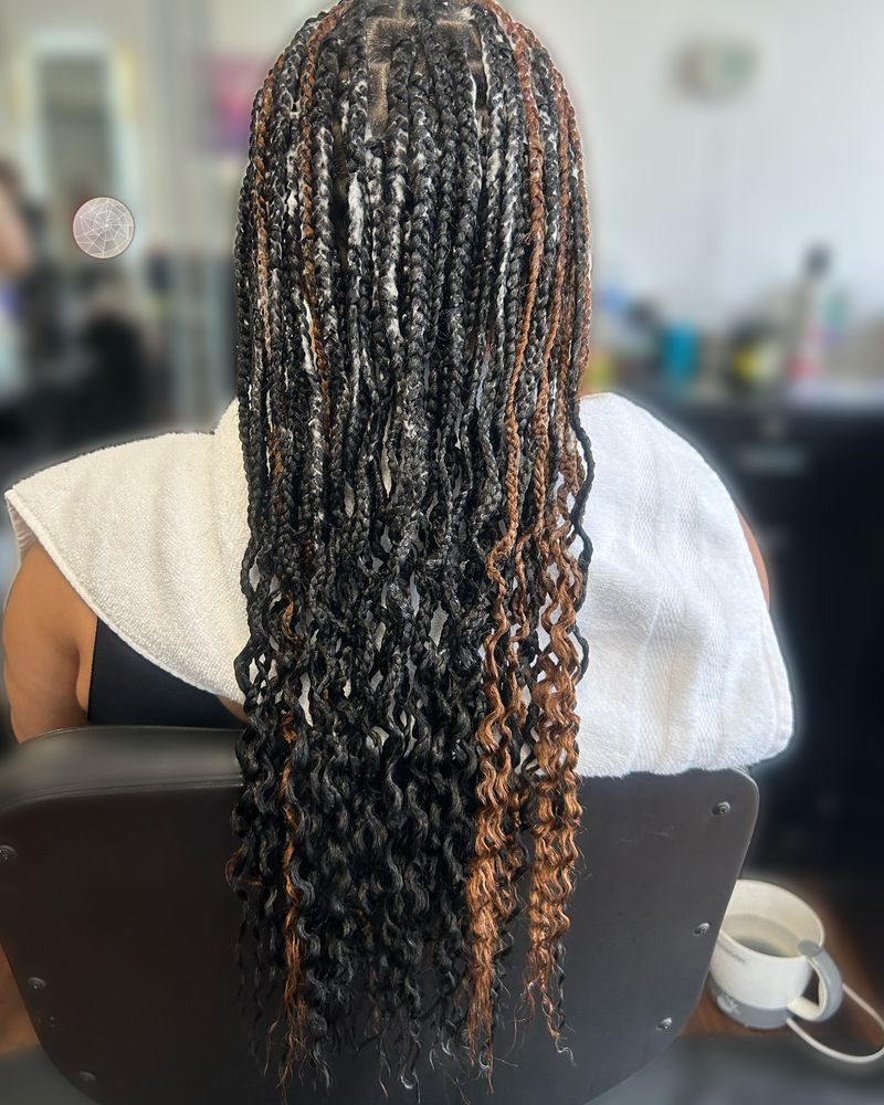 Boho knotless braids with copper highlights and curly ends