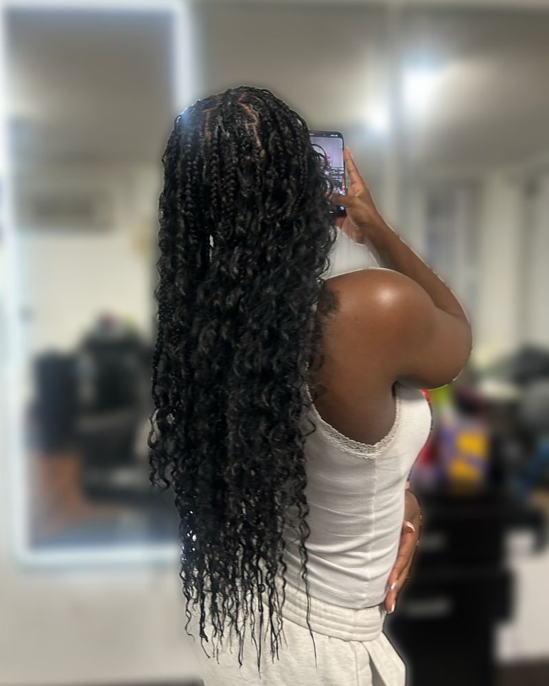 Extra-long boho knotless braids with curly ends, seen from behind
